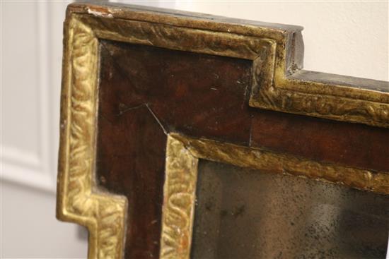 An early 18th century parcel gilt walnut overmantel, with original glass plate W.130cm